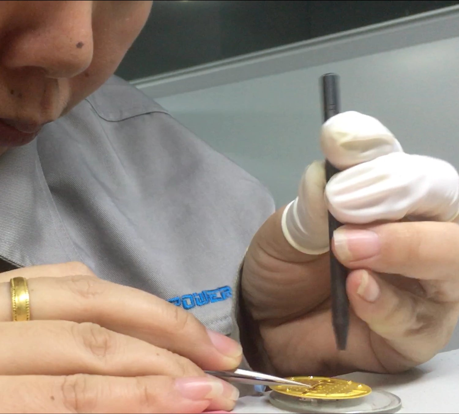 assemble watch hands to dial at watch factory